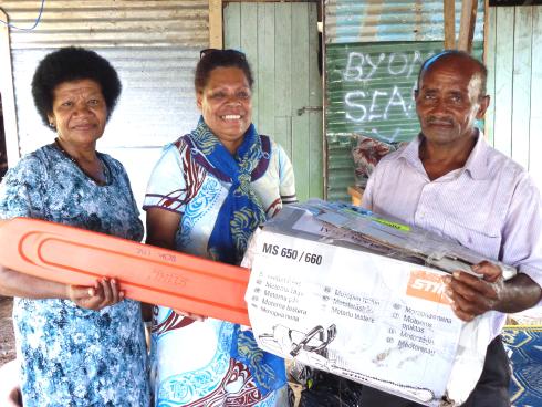 CCIM members Mrs Sisi Marama and Ms Naomi Naubi present a chain saw to catechist Waisea - Photo: Fr Frank Hoare