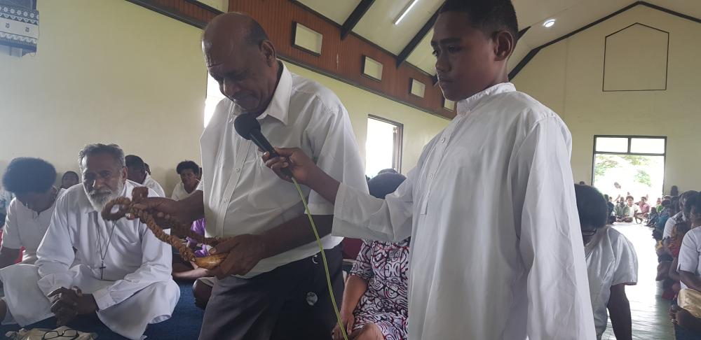 A village elder offers a whale's tooth ('tabua') to the Church to ask forgiveness for past actions - Photo: Fr Patrick Colgan
