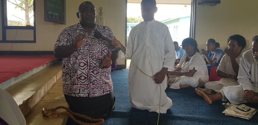 The spokesman of Fr Veremo accepts the tabua on behalf of the Church (during the rite of reconciliation) - Photo: Fr Patrick Colgan