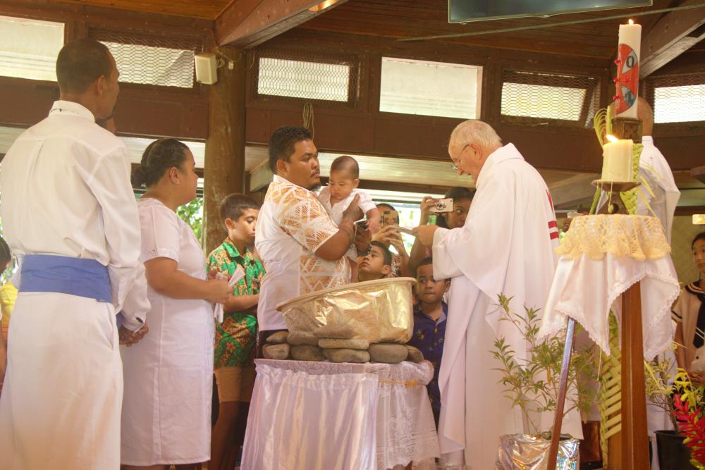 Fr Donal performs a baptism