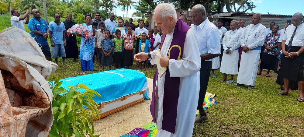 Fr Donal McIlraith blesses the grave at the cemetery - Photo: Fr Donal McIlraith