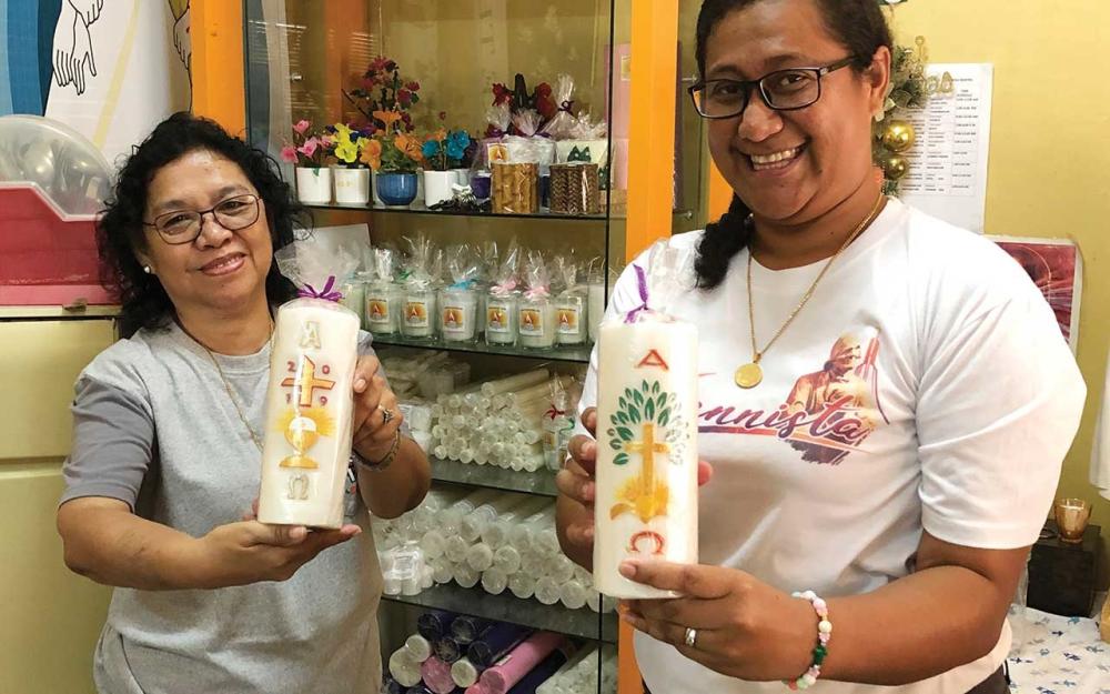 Mrs Gilda Pates (left) and Haiti Muller (right) holding Paschal candles. Photo: Fr Tim Mulroy SSC