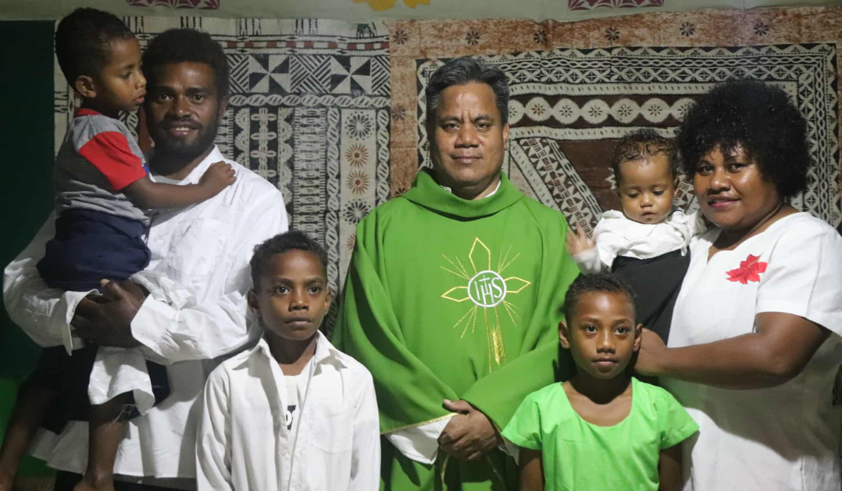 Columban priest – Father Taaremon with the newly baptized and their families. - Photo: Noa Mervyn Tuivunilagi 